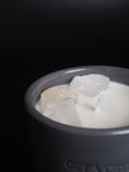 Load image into Gallery viewer, RAW ENERGY - RAW CRYSTAL QUARTZ CRYSTAL INFUSED SMALL GREY CANDLE
